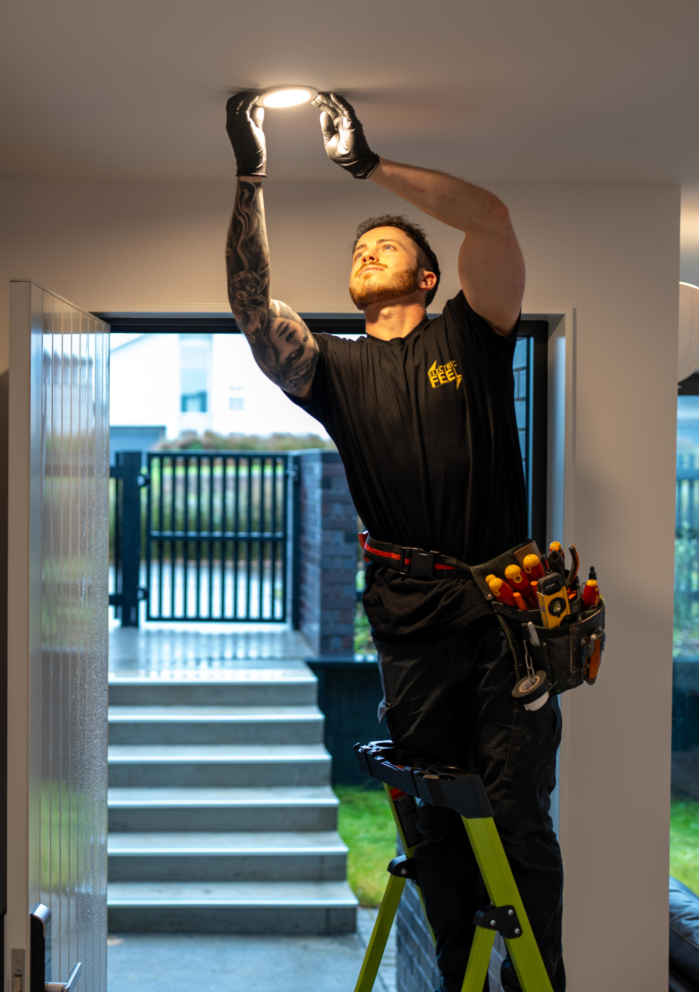 Matt, Auckland electrician at Electric Feel, installing a downlight